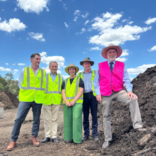 Engineers and Mayor at the Forrest Road Landfill in front of mulch  