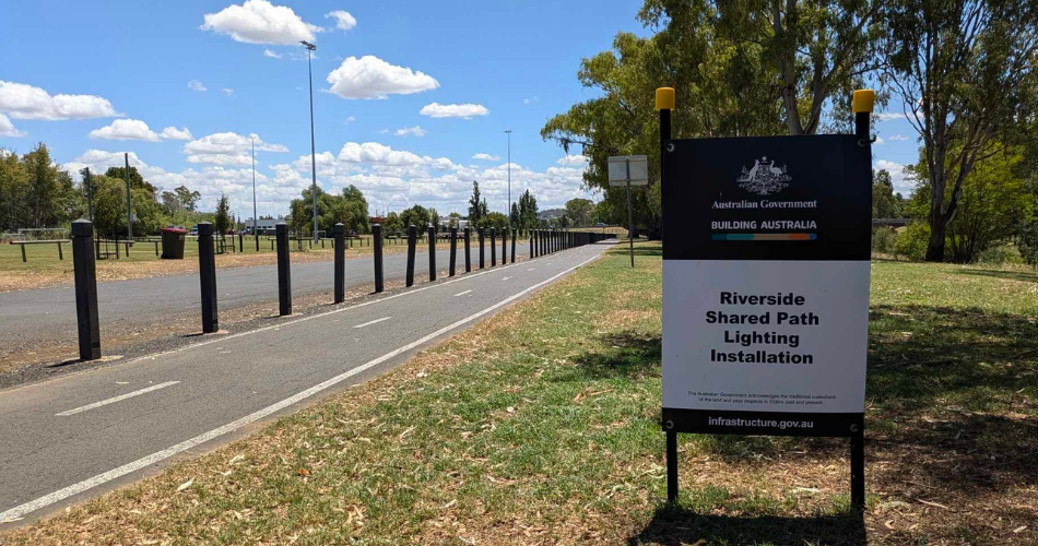 foreground right has a funding sign and ledt hand sign has a pathway disappearing into the background